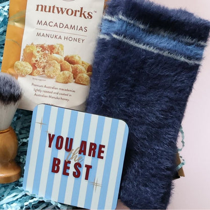 Ultimate birthday gift box for him detail showing Nutworks manuka honey macadamias navy stripe fuzzy socks You Are the Best coaster and shaving brush Perth