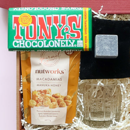 Whisky gift hamper set with whisky glass, stone ice cube, macadamias and chocolate