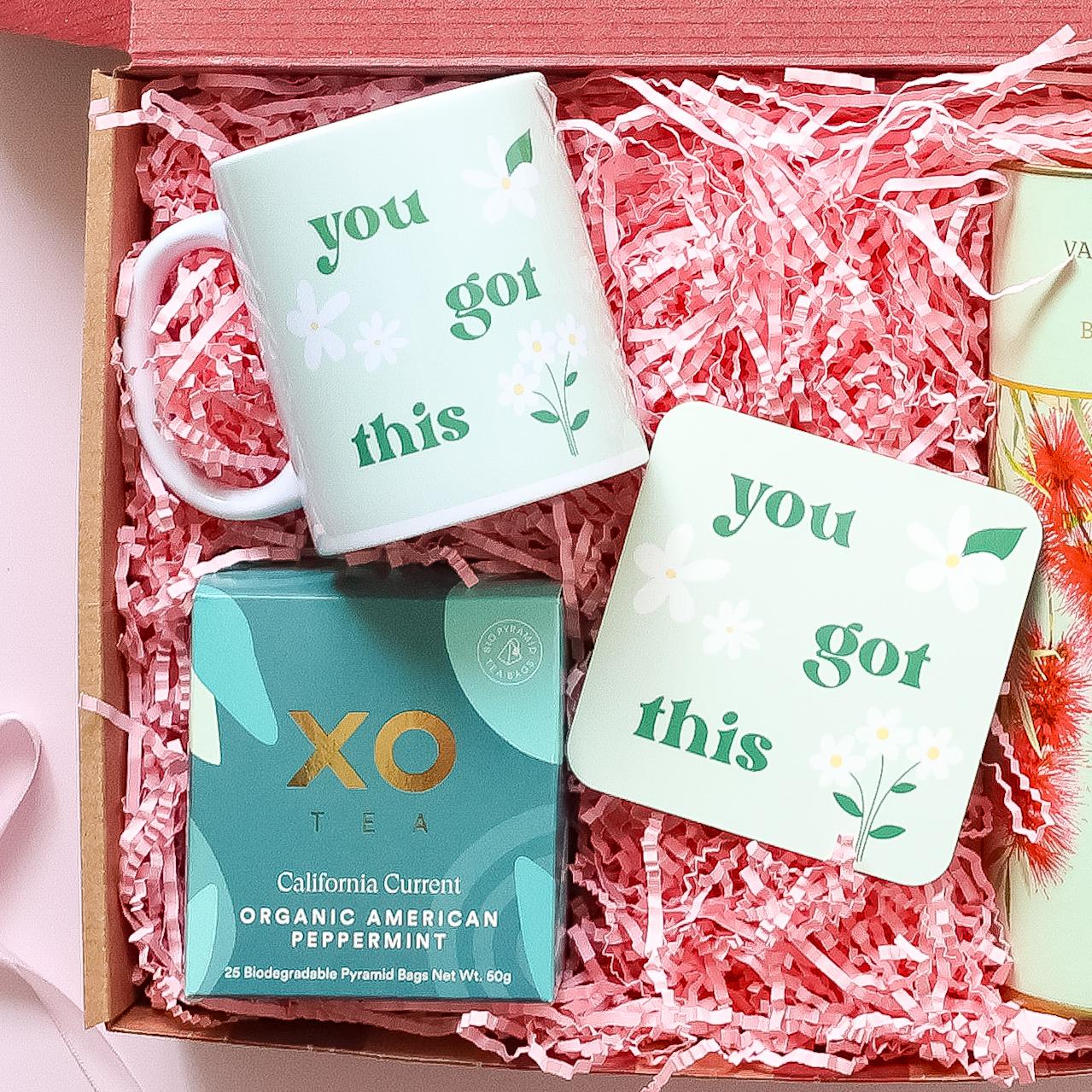 Get well soon care package showing You Got This mug and coaster with XO Tea organic peppermint and Valley Produce Co shortbread