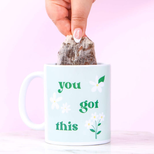 Mug with 'you got this' text and a tea bag being added against a pink background